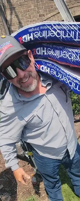 Roofing contractor carrying bags and smiling. Sumner Roofing and Exteriors Contractors in Hendersonville, TN.
