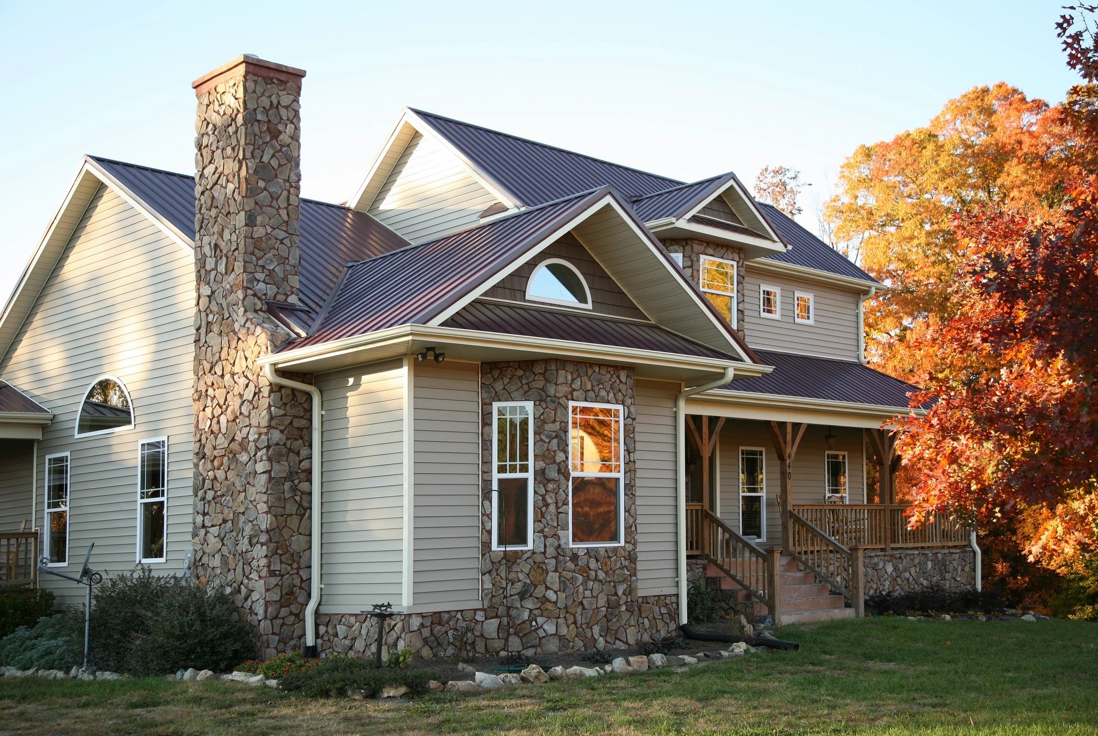 Beautiful home with rock chimney. Chimney Maintenance - Sumner Roofing & Exteriors Hendersonville Sumner County, TN